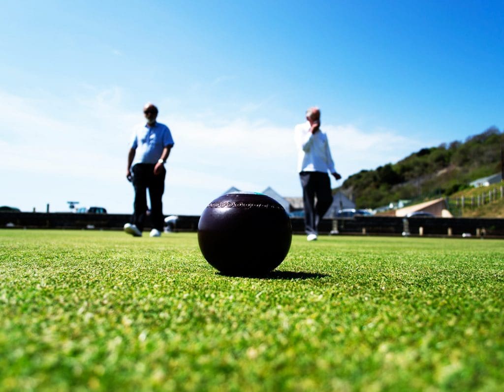 Male and female older adults on bowling green