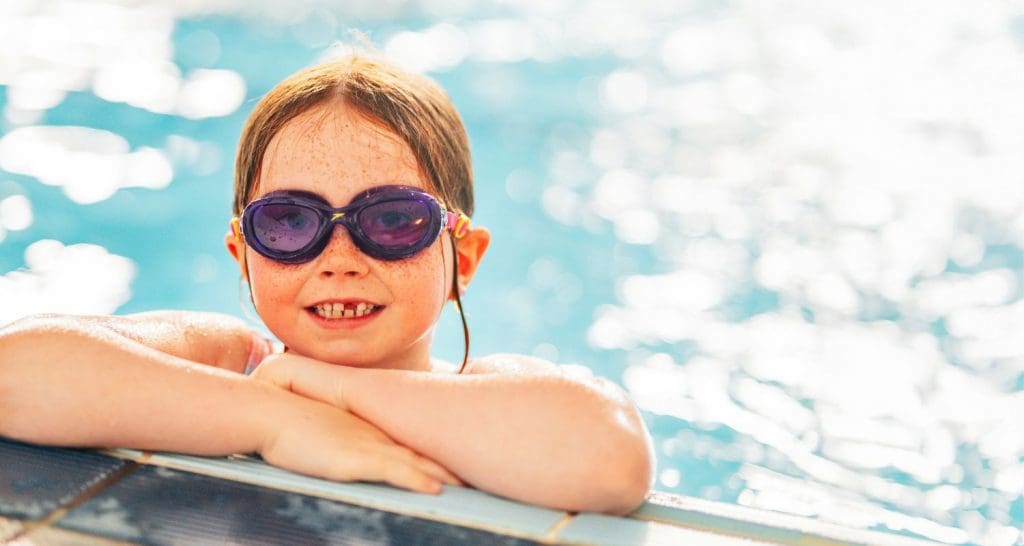 Child smiling at swimming pool